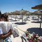 In a photo taken on June 27, 2015, a couple react at the site of the jihadist shooting rampage on the beach in front of the Riu Imperial Marhaba Hotel in Sousse, south of the Tunisian capital, that killed 38 people