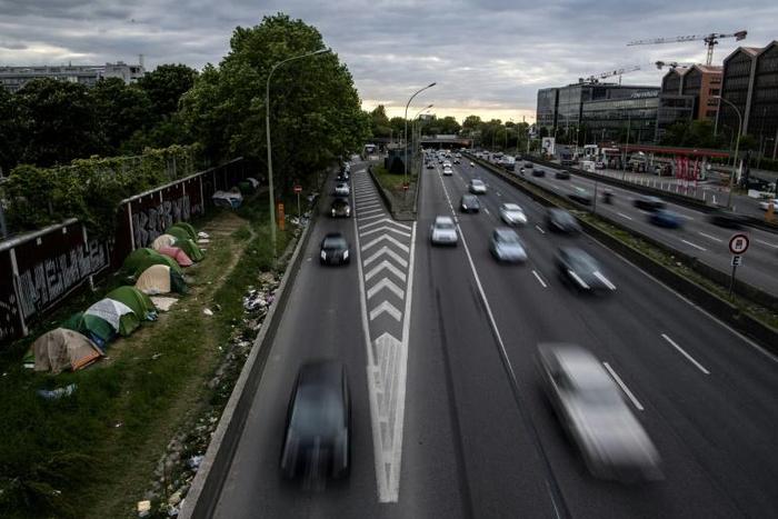 Migrants tents lined up alongside the ring road at the Porte d'Aubervilliers in northern Paris on May 16, 2019.
