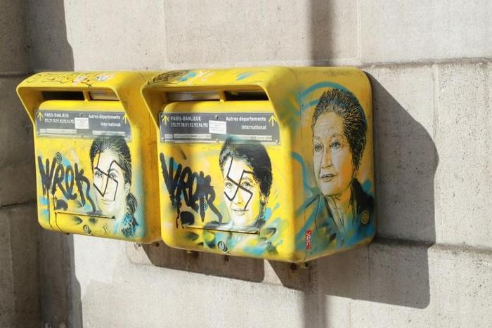 "French society is in trouble," the son of the late Simone Veil said as he looked at the swastikas daubed on two post boxes decorated with pictures of his mother, a Holocaust survivor