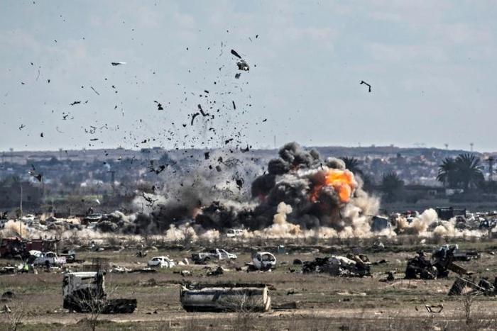 Smoke and fire billow after shelling of the Islamic State group's last holdout of Baghouz, a village in eastern Syria