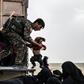 US-backed Syrian Democratic Forces help civilians at a screening area for those who are evacuated from the Islamic State group's embattled holdout of Baghouz, during an operation to expel IS jihadists from the area on February 26, 2019
