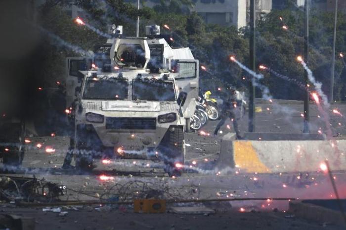 Forces loyal to President Nicolas Maduro confront supporters of opposition leader Juan Guaido