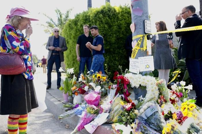 Mourners and well wishers leave flowers at a makeshift memorial across the street from the Chabad of Poway Synagogue on Sunday, April 28, 2019 in Poway, California, one day after a teenage gunman opened fire, killing one person and injuring three