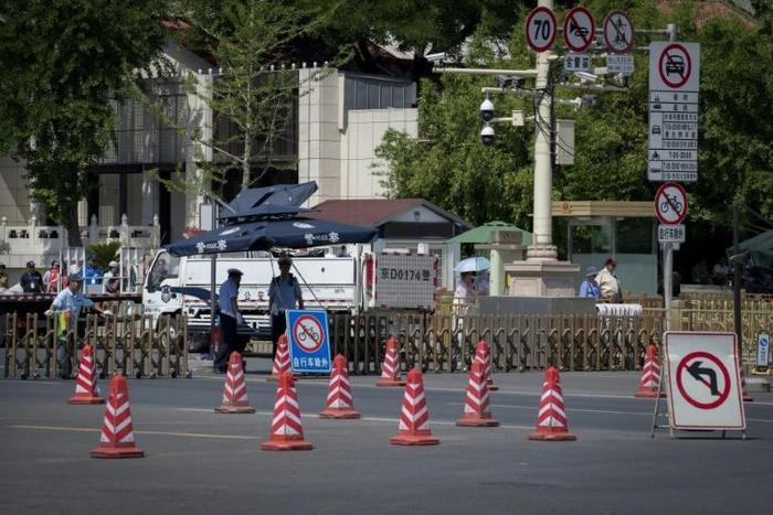 Police officers stand behind barriers as Tiananmen Square is closed off for the 30th anniversary of China's crackdown on pro-democracy demonstrators
