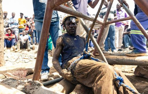 Artisanal miners known as "makorokoza" have arranged wooden logs around pits in makeshift attempts to help with the rescue operation