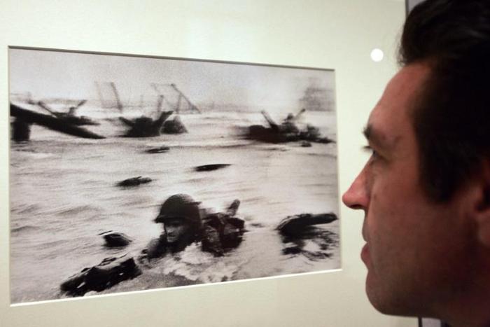 Hungarian-born photographer Robert Capa's legendary photo of the D-Day landings 75 years ago, on exhibition in Paris in 2004