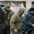 A Russian FSB security service officer escorts a detained Ukrainian sailor in Crimea in November -- a total of 24 sailors are still being held by Russia along with three naval vessels from Ukraine