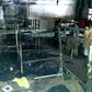 Investigators work after a fire in a shelter for migrants in the town of Velika Kladusa