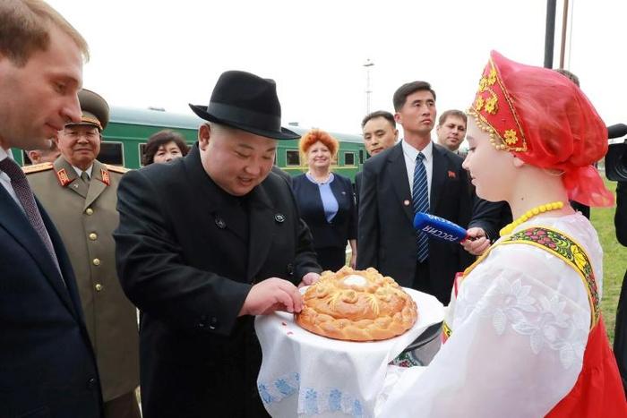 Kim was greeted by women in folk costumes with bread and salt in a traditional greeting