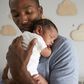 A daddy holding his new born baby.