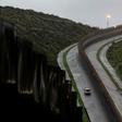 A US Border Patrol vehicle drives near a section of reinforced US-Mexico border fence near Tijuana, Mexico