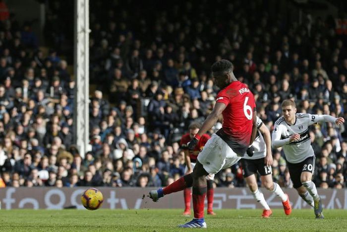 Easy does it: Paul Pogba scores his second goal from the penalty spot in Manchester United's 3-0 win away to Fulham