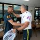 Happy to see you: the Brazilian Football Confederation released a photo showing coach Tite greeting Richarlison, the first player to turn up at a sparsely attended training camp