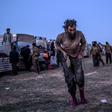 Suspected members of the Islamic State group are among thousands leaving the jihadists' last Syrian stronghold