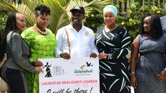 Uganda's Tourism Minister Godfrey Kiwanda posed with women during the launch of the Miss Curvy beauty contest in the capital Kampala