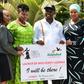 Uganda's Tourism Minister Godfrey Kiwanda posed with women during the launch of the Miss Curvy beauty contest in the capital Kampala