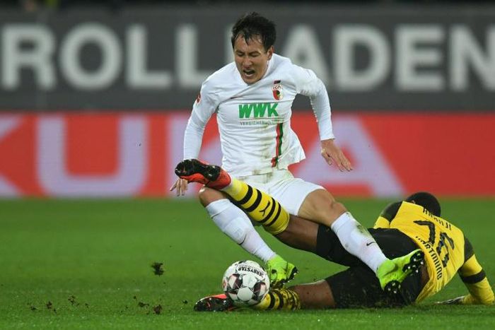 Augsburg's South Korean forward Ji Dong-won scored twice on Friday as Bundesliga leaders Borussia Dortmund crashed to a shock 2-1 defeat in Bavaria.