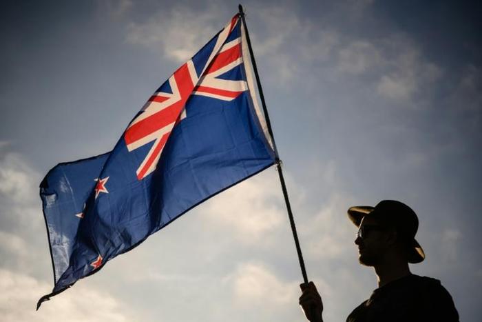 A New Zealand flag held at a vigil for the Christchurch mosque massacres. New Zealand has offered permanent residency to those directly affected by the attacks