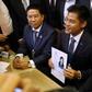 A party official holds a registration document bearing the image of Thai Princess Ubolratana, who will run for PM