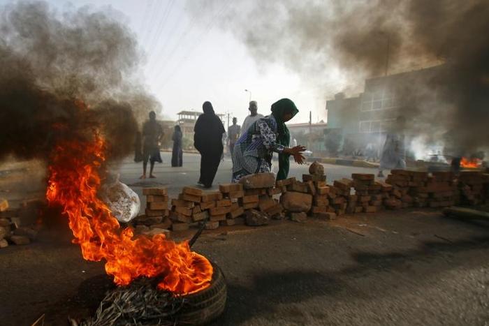 Sudanese protesters close Street 60 with burning tyres and pavers as military forces tried to disperse a sit-in outside Khartoum's army headquarters on June 3, 2019.At least two people were killed Monday as Sudan's military council tried to break up a ...