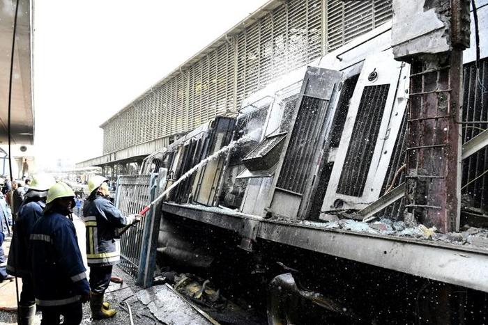 Fire fighters at the scene of a train crash in the Egyptian capital on February 27, 2019