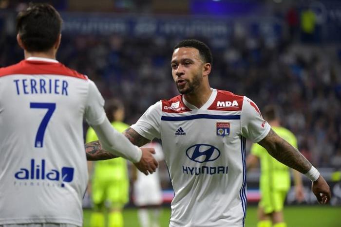 Lyon's Dutch forward Memphis Depay (R) reacts with French midfielder Martin Terrier during the French L1 football match against Angers in Decines-Charpieu, near Lyon, central-eastern France.