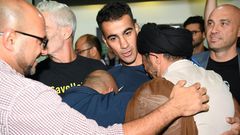 Hakeem al-Araibi (C) was greeted by a throng of well wishers at Melbourne Airport after an overnight flight to freedom