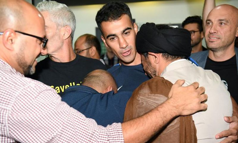 Hakeem al-Araibi (C) was greeted by a throng of well wishers at Melbourne Airport after an overnight flight to freedom