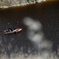 A boat equipped with a sonar system sails on the acidic Red Lake near the village of Mitsero, southwest of Cyprus' capital Nicosia, searching for bodies of victims of a suspected serial killer