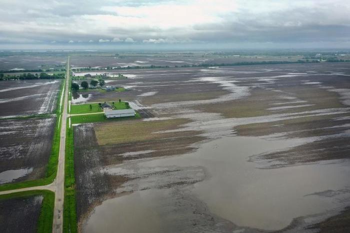 American farmers have been battered by flooding and the trade war with China, but the Federal Reserve found the economy is generally showing signs of solid but modest growth