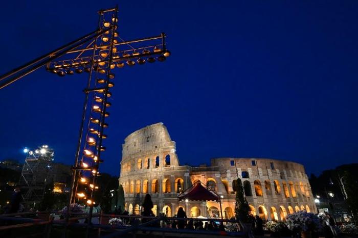 A cross lit with candles in front of the Coliseum in Rome ahead of the Way of the Cross procession