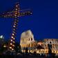 A cross lit with candles in front of the Coliseum in Rome ahead of the Way of the Cross procession
