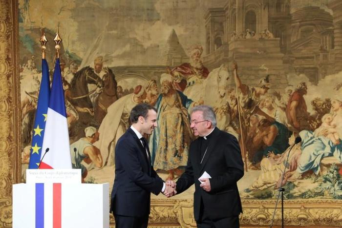French President Emannuel Macron shakes hands with Apostolic Nuncio to France Luigi Ventura who is being investigated for sexual assault