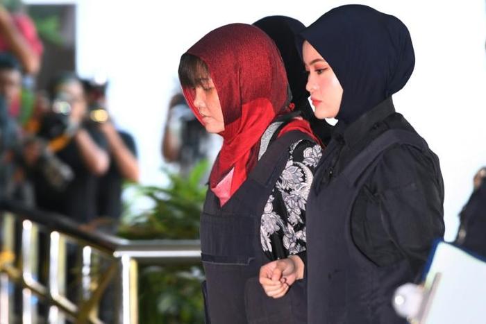 Vietnamese national, Doan Thi Huong (2nd R)is escorted by Malaysian police at the Shah Alam High Court, outside Kuala Lumpur, on March 14, 2019 to stand trial for her alleged role in the assassination of Kim Jong Nam
