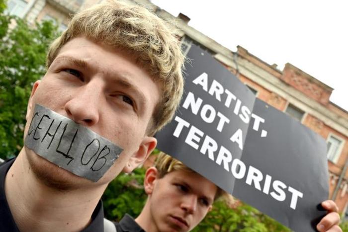Protesters marched in Kiev with the mouths taped shut to mark the fifth anniversary of Ukrainian film director Oleg Sentsov's arrest