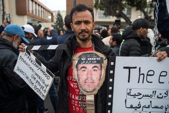 Supporters of Morocco's al-Hirak al-Shaabi movement hold placards and shout slogans calling for the release of the movement's members outside the Casablanca Court of Appeals during their trial on April 5, 2019