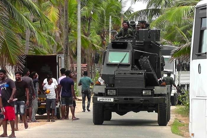 Soldiers patrol in Kalmunai where three suicide bombers blew themselves up during a raid by troops and police on Friday