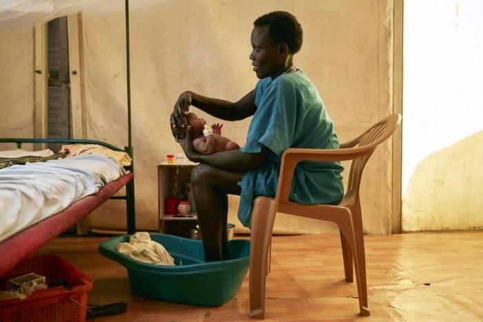 A mother washes her newborn infant at a hospital in a protected civilian site in Malakal, South Sudan. To encourage the peace process the Vatican is hosting a retreat for the warring rival leaders