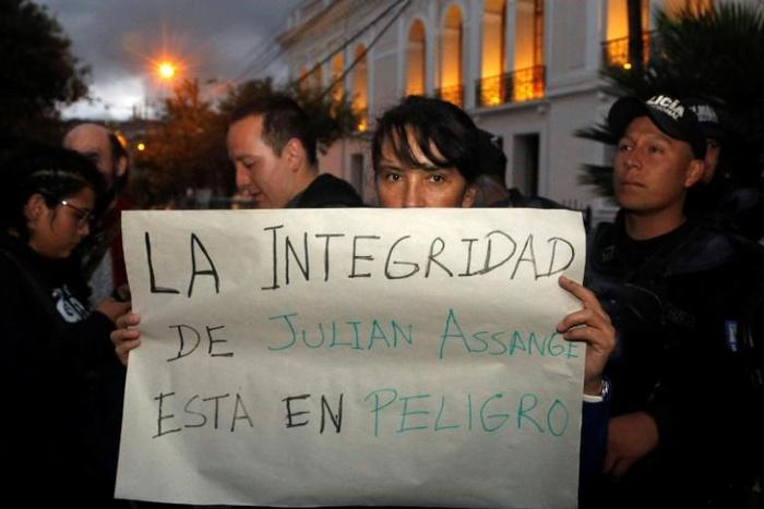 A protester outside the Foreign Ministry in Quito, Ecuador holds a placard reading "Assange's Safety is in Danger," after British police took WikiLeaks founder Julian Assange out of Ecuador's embassy in London and arrested him