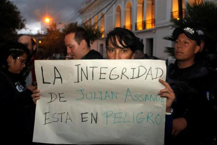 A protester outside the Foreign Ministry in Quito, Ecuador holds a placard reading "Assange's Safety is in Danger," after British police took WikiLeaks founder Julian Assange out of Ecuador's embassy in London and arrested him