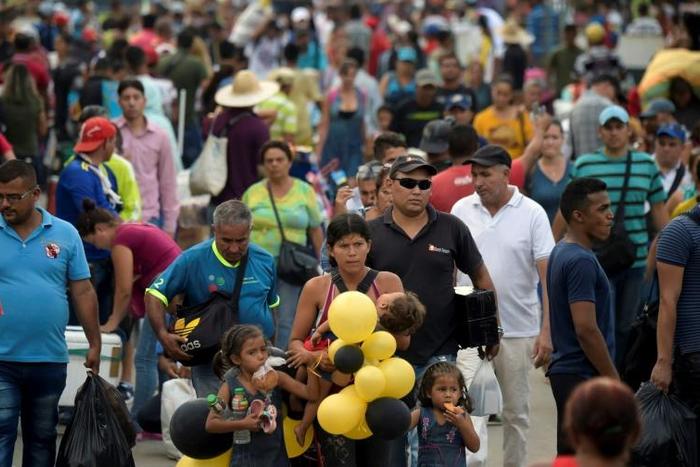 Tens of thousands of people a day cross the Simon Bolivar International Bridge between Venezuela and Colombia