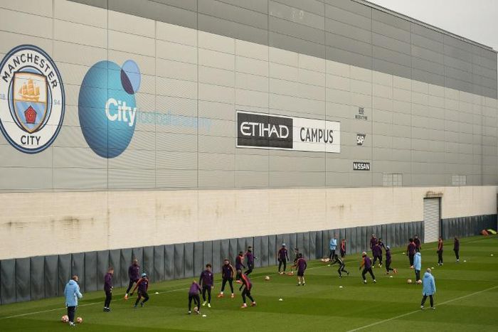 In the money: Manchester City players attend a team training session at the club's academy