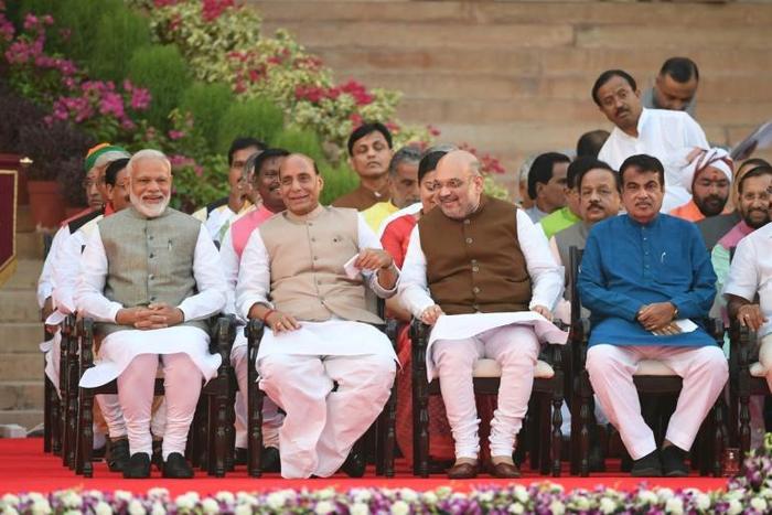Narendra Modi (L) sits next to BJP President Amit Shah (2R) and Minister of Home Affairs of India Rajnath Singh (2L) before Modi's swearing-in ceremony as Indian Prime Minister at the President house in New Delhi on May 30, 2019