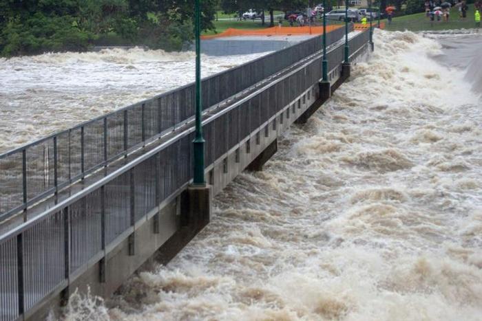 A recent undated picture provided by the Queensland Fire and Emergency Services and received by AFP on February 3, 2019 shows floodwaters as they rush over the Aplins Weir in Townsville after days of torrential rain