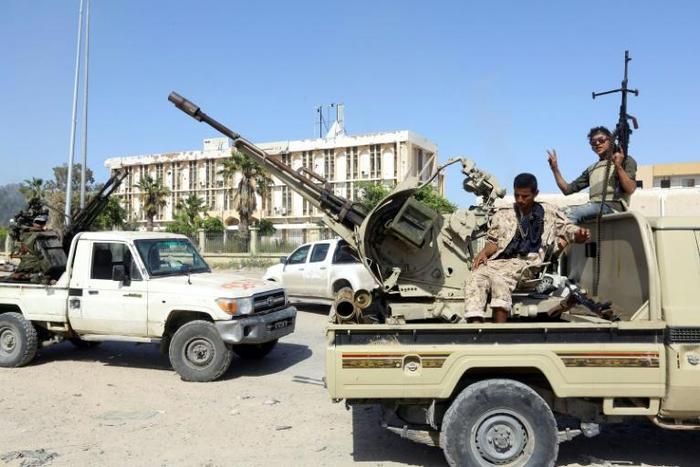 Forces loyal to Libya's Government of National Accord (GNA) gesture on April 18, 2019, after taking control of the area of al-Aziziyah, located some 40 kilometres south of the Libyan capital Tripoli, following fierce clashes with forces loyal to strong...