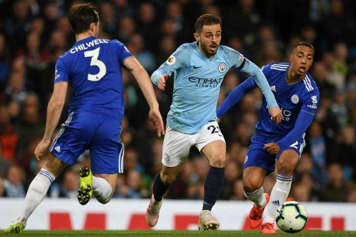Treble chance - Manchester City's Bernardo Silva (C) in action against Leicester