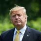 US President Donald Trump walks across the South Lawn of the White House after returning from Japan