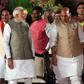 This photograph taken on May 30, 2019, shows newly sworn-in Indian Prime Minister Narendra Modi (L) talking with cabinet minister Rajnath Singh (C) and Amit Shah (R) after taking the oath of office at the President house in New Delhi