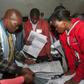 Scrutiny: Polling staff and representatives of political parties monitor the vote count at a polling centre in Blantyre