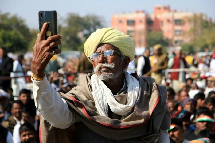 Smartphone users in emerging nations such as India, where this farmer is seen at a rally, say they get benefits from the devices but worry about the impact of digital technology on children